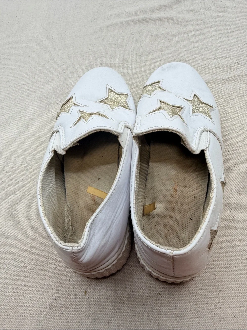 ' White Slip-On Sneakers with Gold Star Accents